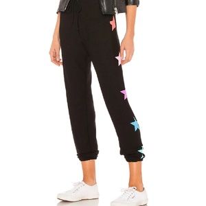 Black Chaser sweatpants with multi colored stars on side